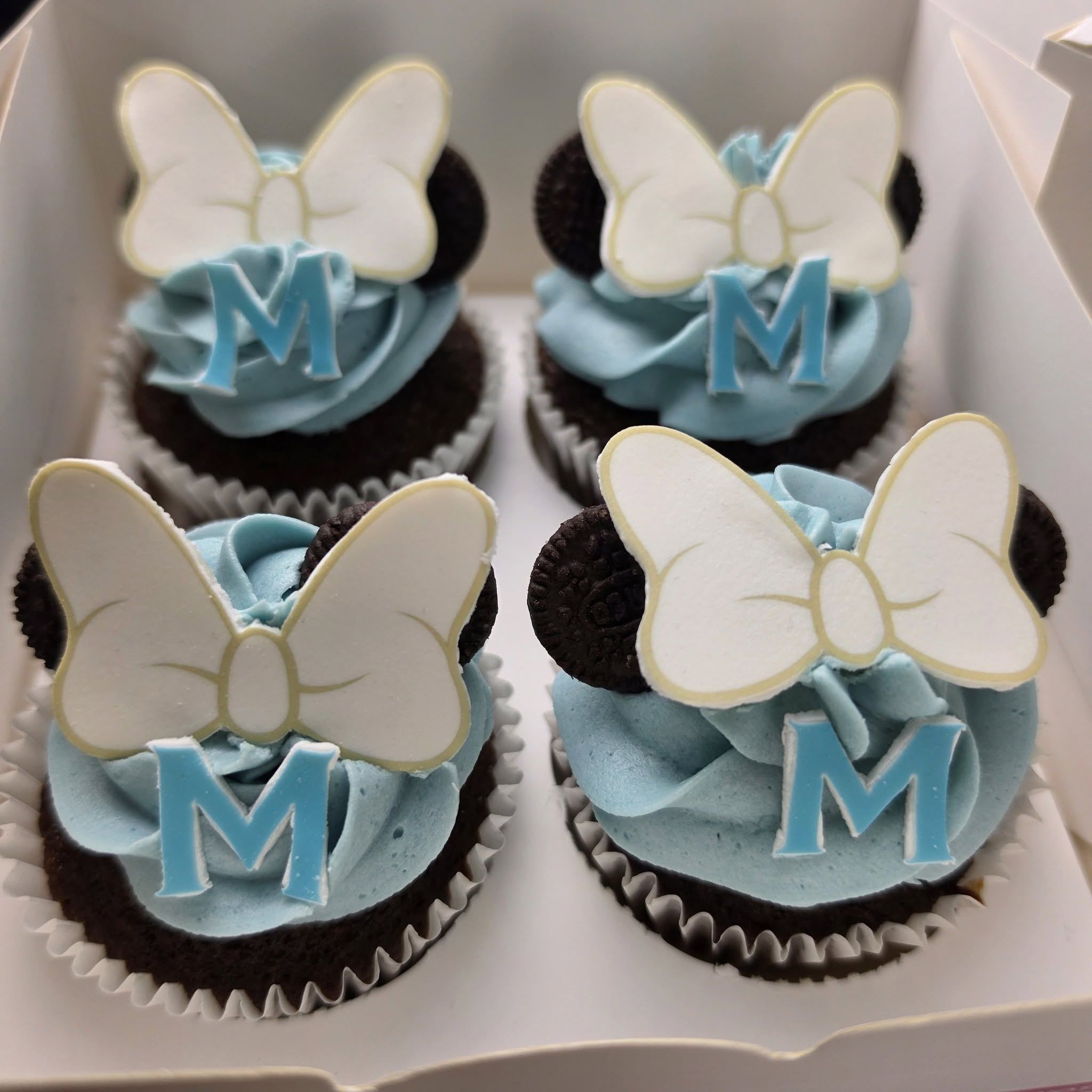 Blue bow-themed chocolate cupcakes