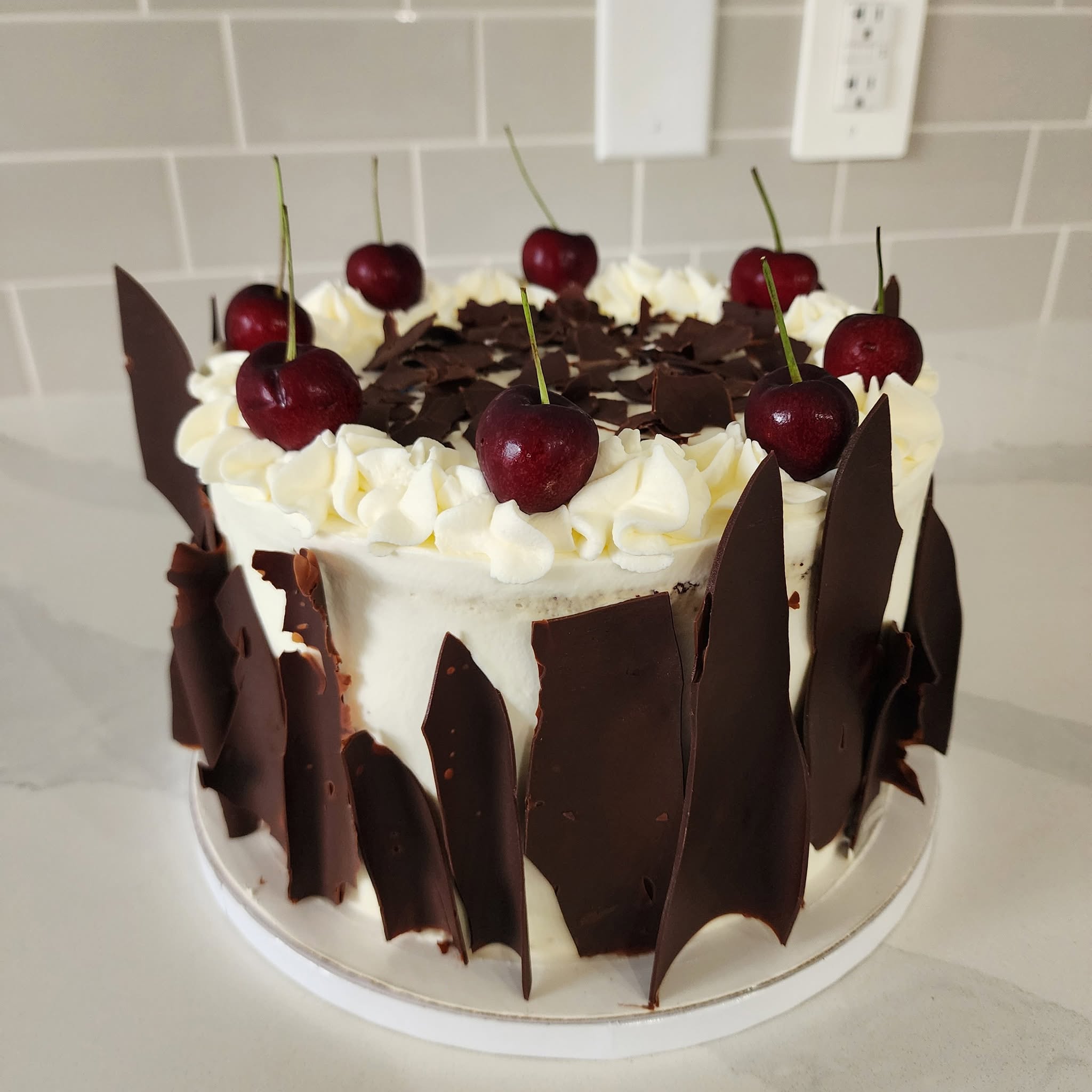 Cherry and chocolate decorated celebration cake