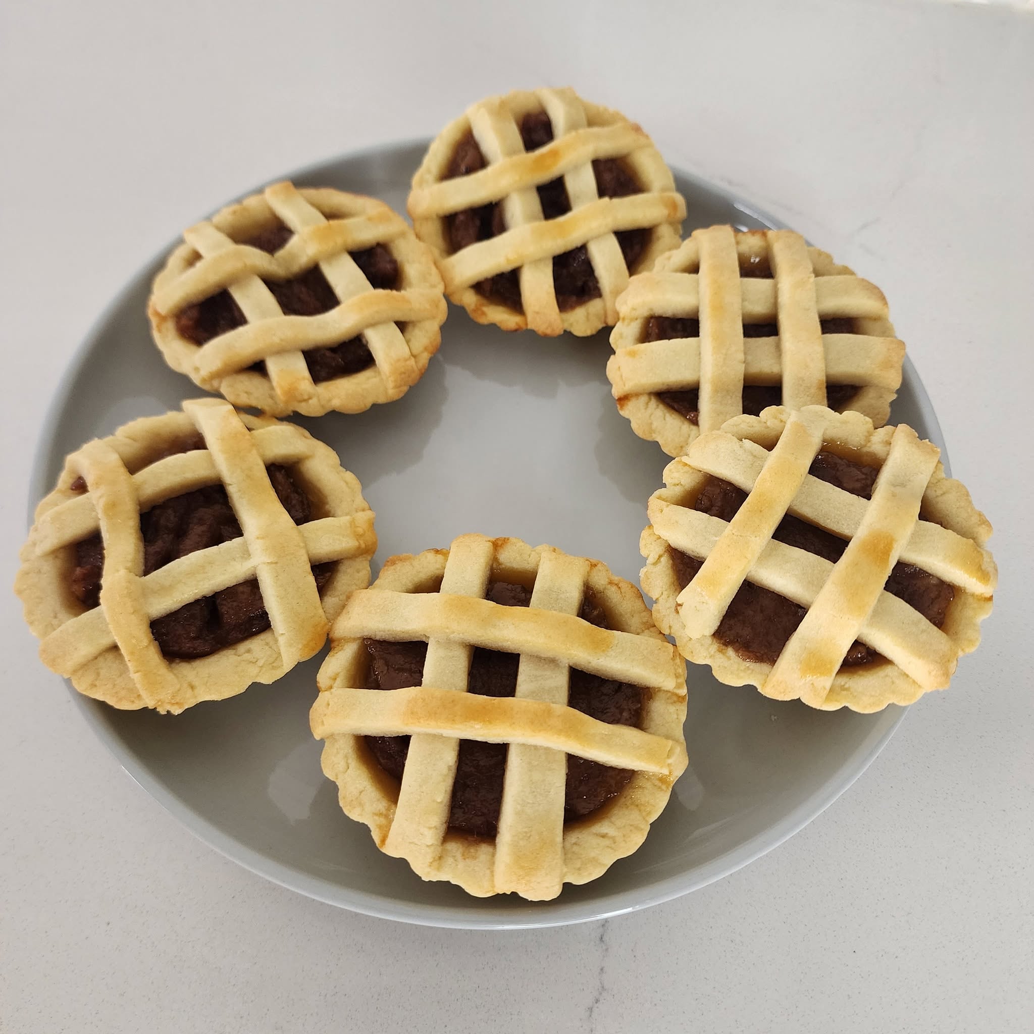 Freshly baked individual lattice-topped pies